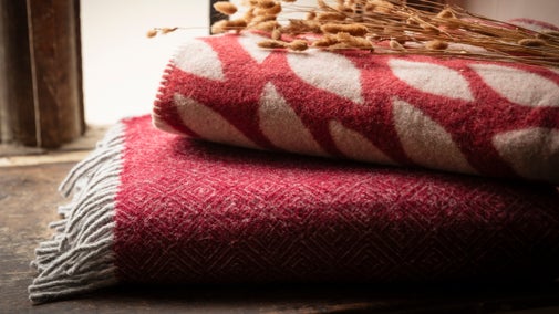 Two throws in a pile, one with a diamond weave